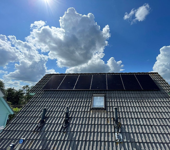 Zonnepanelen in Workum op schuurdak met wolkenlucht